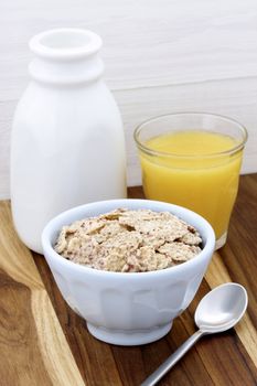 Delicious and healthy breakfast cereal with milk and orange juice