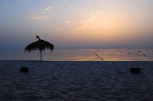 gorgeous sunrise over tranquil sea water on beach in Tunisia