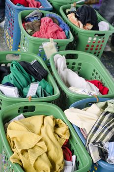 A line of laundry baskets full of dirty clothes for washing