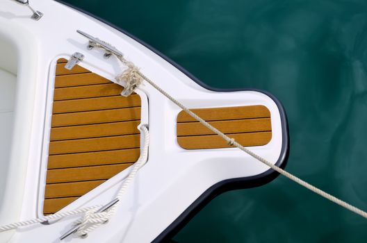 Top shot of bow of white speed boat on water