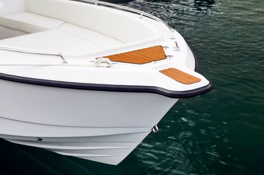 Close-up shot of bow of white speed boat on water