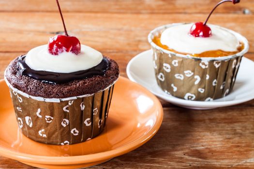 Chocolate and Butter Marmalade Cupcakes decorated with red cherry