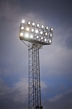 Stadium Lights in front of cloudy sky