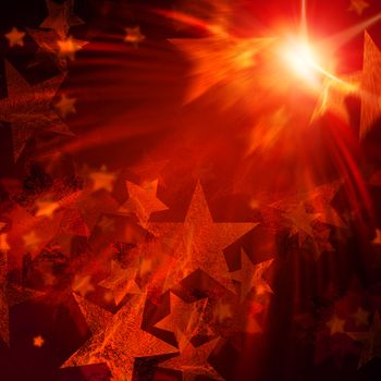 abstract shining stars with orange rays lights over dark background