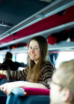 Smiling girl traveling by bus