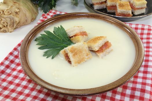 a bowl of Cream of celery soup with salmon croutons