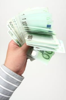 Businessman holding stack banknotes in EUR 100