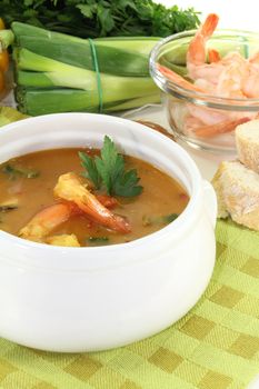 fresh bouillabaisse with shrimp and parsley on a light background