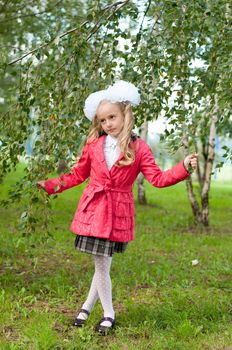 Schoolgirl dressed in a birch forest