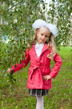 Schoolgirl dressed in a birch forest