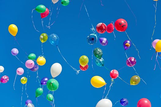 Colorful balloons on a blue sky background