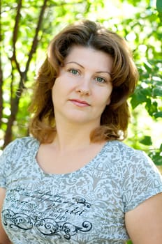 Middle-aged woman in a summer park