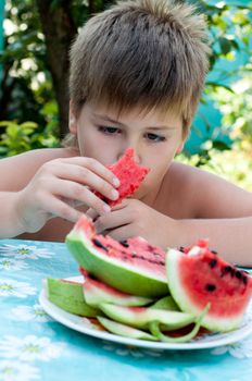 Boy eating a ripe watermelon