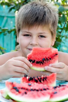 Boy eating a ripe watermelon