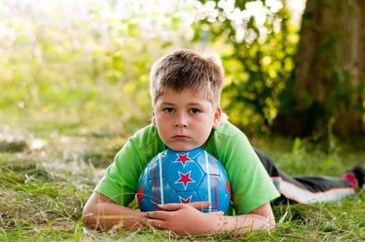 The boy with the ball on the nature