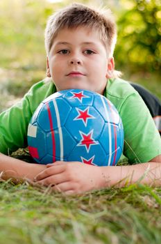 The boy with the ball on the nature