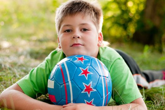 The boy with the ball on the nature