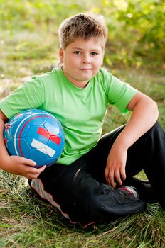 The boy with the ball on the nature