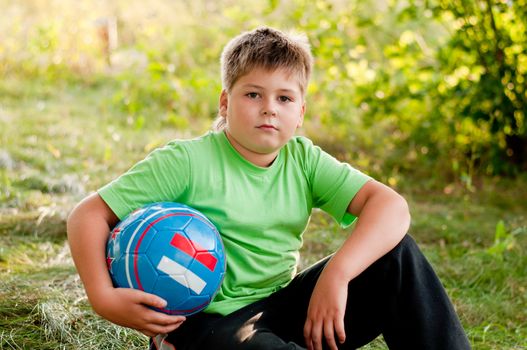 The boy with the ball on the nature