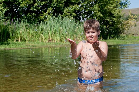 A boy swims in the river