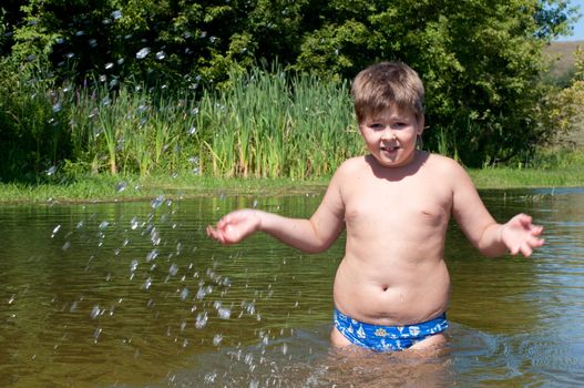 A boy swims in the river