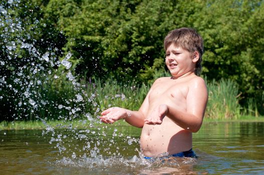 A boy swims in the river