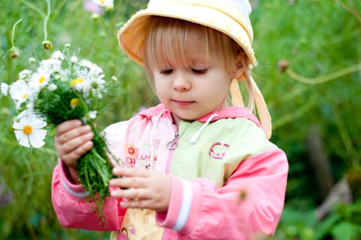 Little girl with flowers 2.5 years