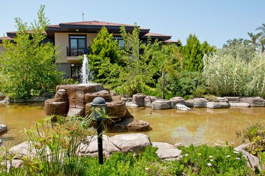 Landscaping - a stone fountain and pond