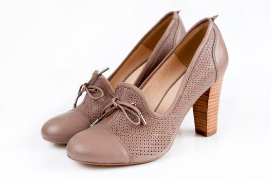 Beige female shoes on a light background