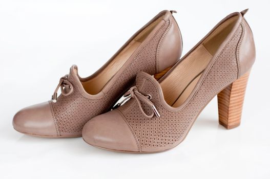 Beige female shoes on a light background