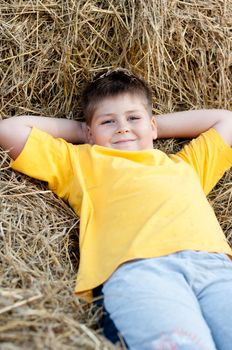 Boy lying on the straw