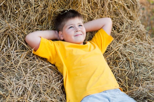 Boy lying on the straw