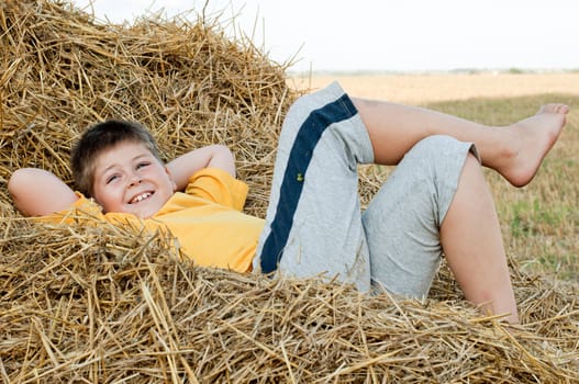 Boy lying on the straw