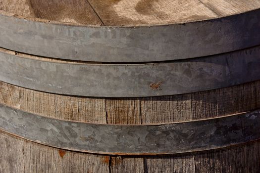 Detail of an old rosty wooden barrel of liquor. Shallow focus.