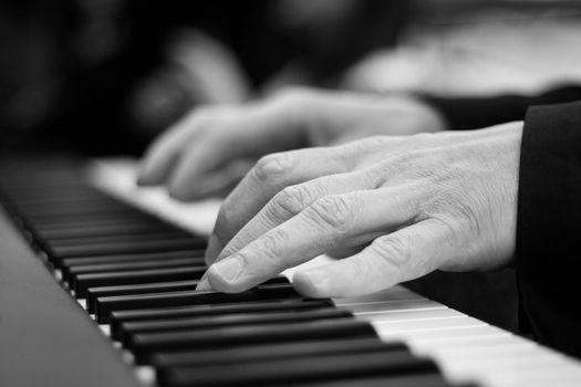 Close-up on a man's hand playing the piano