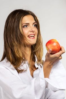 Woman with apple in man`s shirt