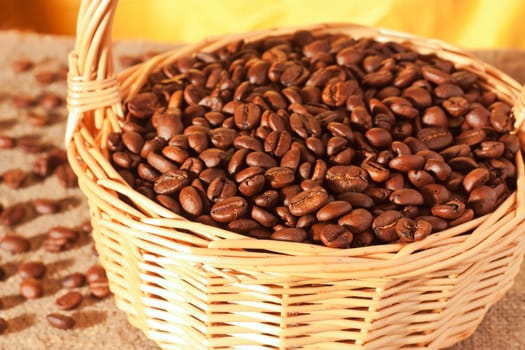 Roasted coffee beans in a wicker basket on the table