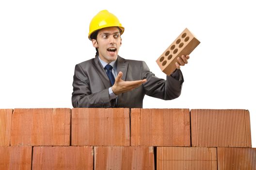 Businessman with bricks on white