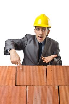 Businessman with bricks on white