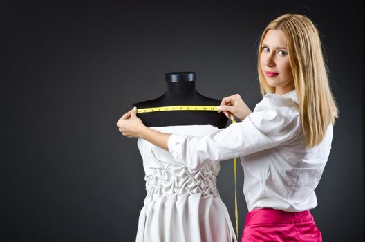 Woman tailor working on dress 