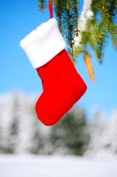 Santa Claus Christmas boot for gifts outside in a snowy landscape