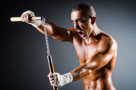 Strong man with nunchaku