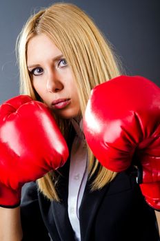 Woman boxer in dark room