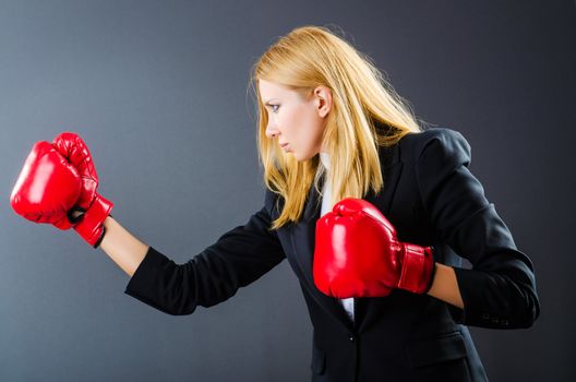 Woman boxer in dark room