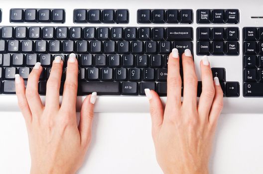 Hands working on the keyboard