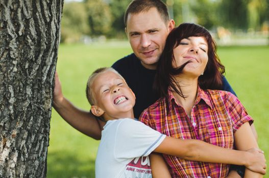 Young family play and  smile each other in the park