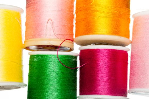 Many colors of cotton thread on bobbins