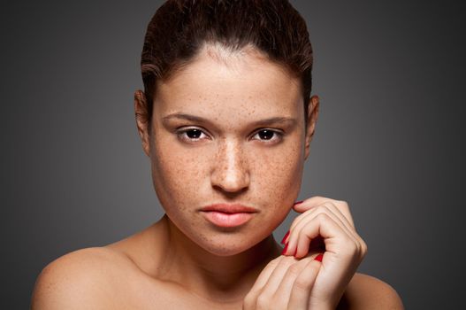 Portrait of young woman isolated on grey background