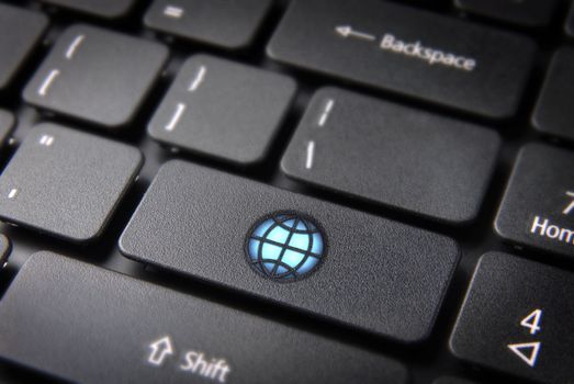 Internet global business concept: key with bright World icon on laptop keyboard. Included clipping path, so you can easily edit it.