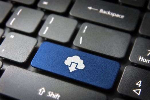 Technology concept background: blue key with cloud computing download icon on laptop keyboard. Included clipping path, so you can easily edit it.